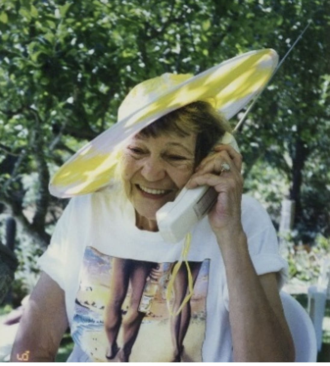 old woman talking on retro cordless phone